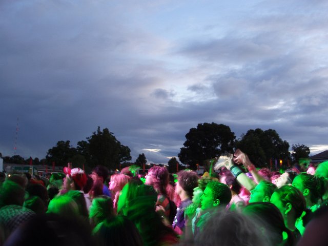 audience at a music festival, surreal green light