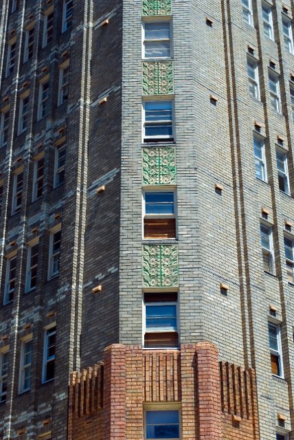 study of the brickwork on an art deco style appartment block with floral tile motif