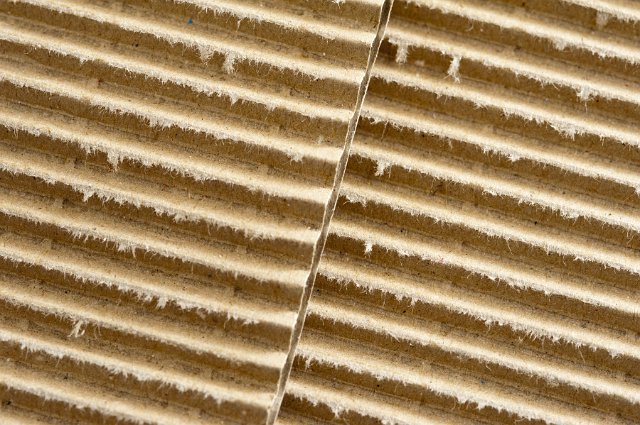 Corrugated cardboard background texture for use in retail packaging and cartons, full frame close up view
