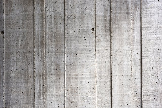 A close up of a washed out, rustic timber shuttered concrete wall background.