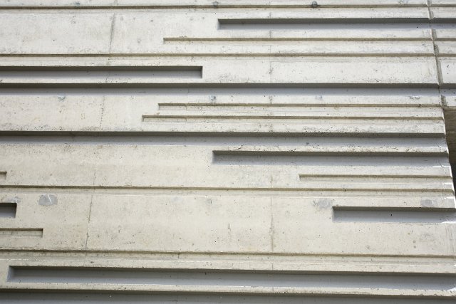 Formed concrete wall with horizontal linear design in a close up full frame low angle view
