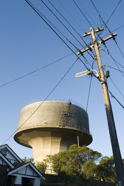 wide angle view of a water tower against a blue sky