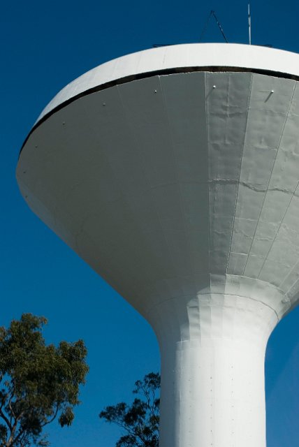 a white painted concrete conical water tower