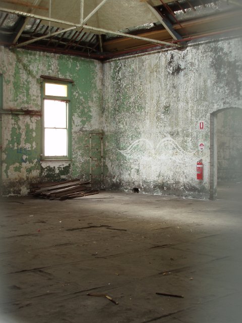 old derelict building interior with paint flaked walls
