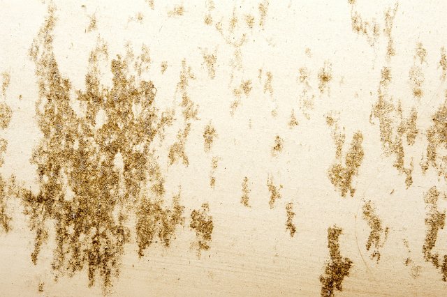 Rustic stains on old white painted metal surface, viewed in close-up full frame for background concept