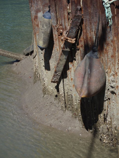 a rusty quayside made from metal pilings