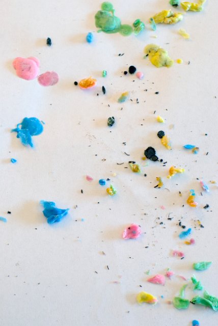 scraping of coloured wax on a studio work surface