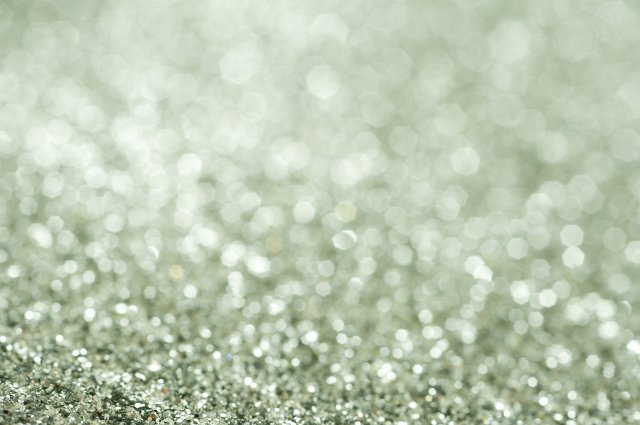 Green glitter background texture with shallow DOF and copy space for your Christmas or festive greeting, full frame