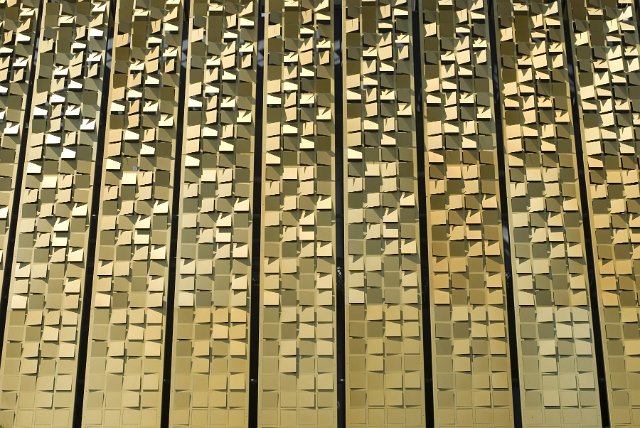 Architecutral metal cladding in a gold colour creates an interesting texture or backdrop