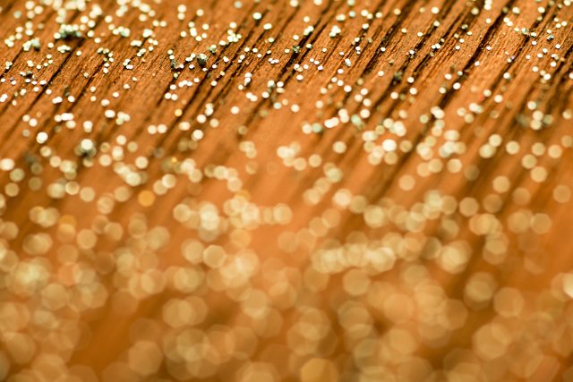Warm festive background bokeh of sparkling golden lights for celebration, party or holiday themes