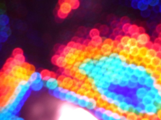 colorful background composed of diffuse overlapping bokeh circles in various bright colours