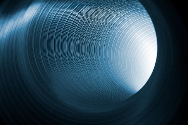 abstract image of light glowing at the end of a metal tube