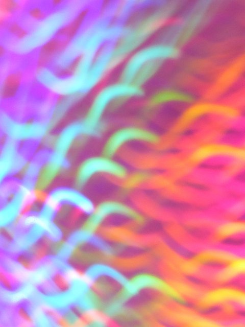 rainbow of softly curved light trails forming gentle s patterns