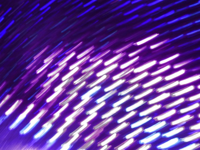purple and blue glowing bakground of vivid light motion blurs