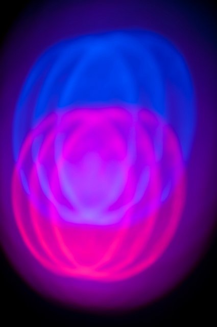 red and and blue mixing light creating purple