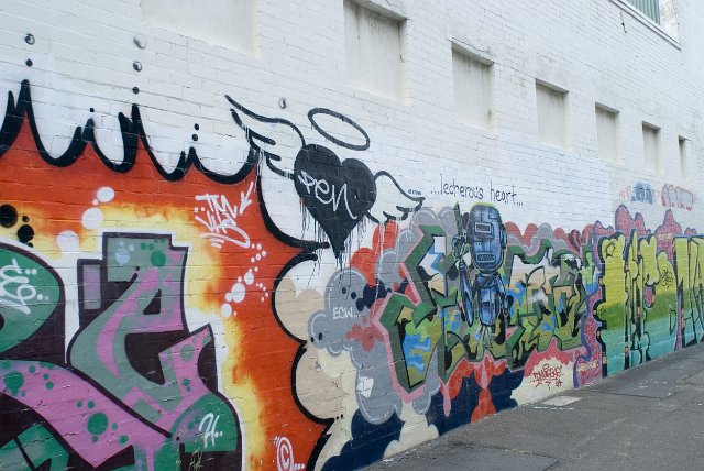 a long wall of graffiti artwork
