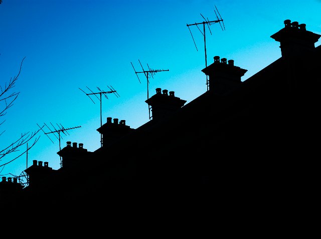 silhouette of roof tops and aerials
