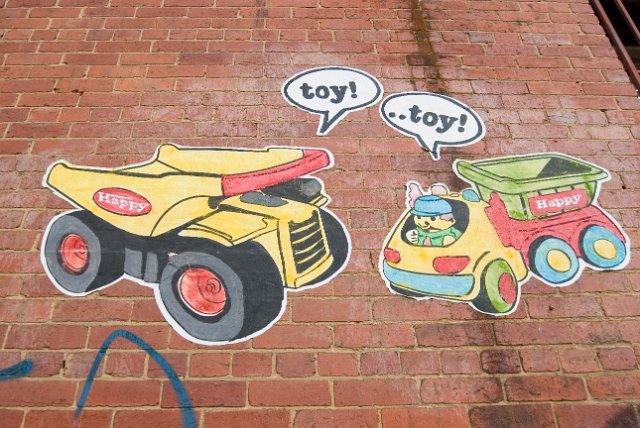 decorative ruban artworks on a brick wall