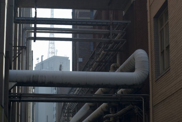 a maze of pipes in a disused industrial building