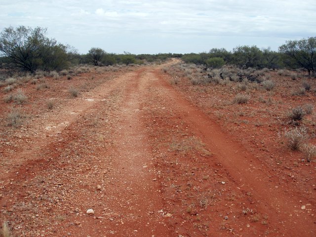 looking down a red dirt road