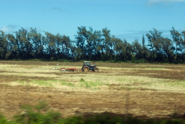 a tractor pulling a plough through a field