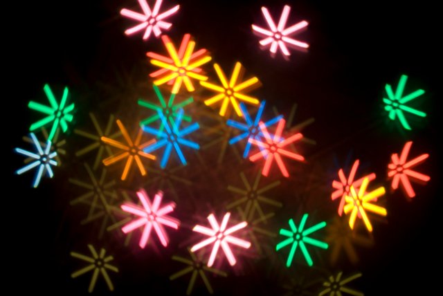 a pattern of colourful bokeh star shapes