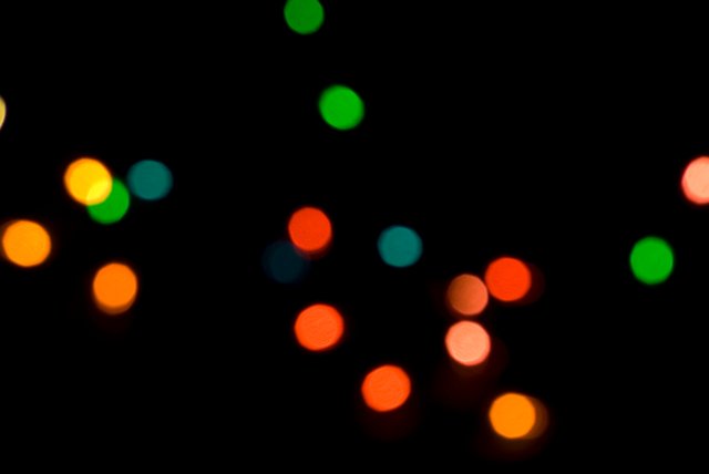 a minimalist black background comprised of coloured bokeh circles