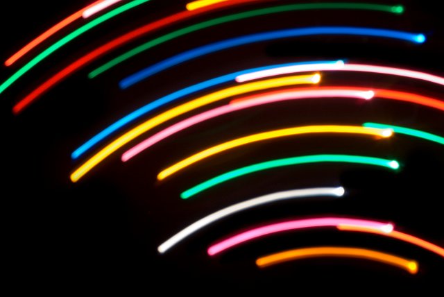 colourful arcs of light used to produce an eye catching background on black