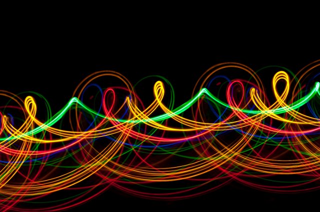 a looping background pattern of multi coloured light trails