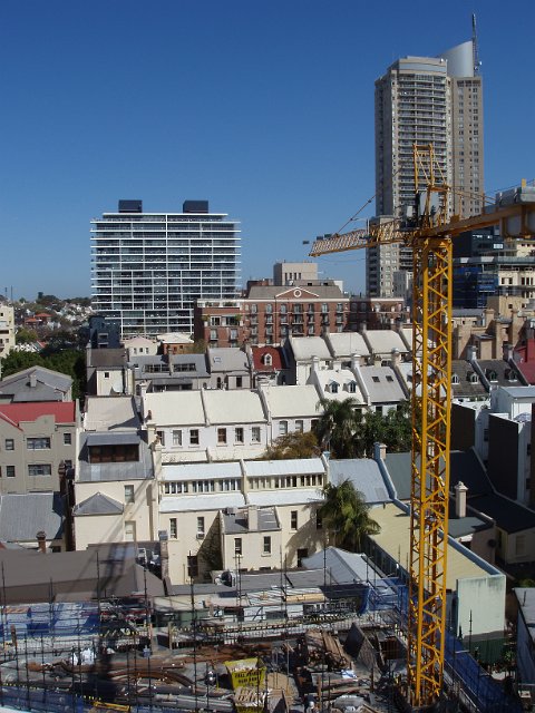 aerial view of a tower crane at an urban construction site