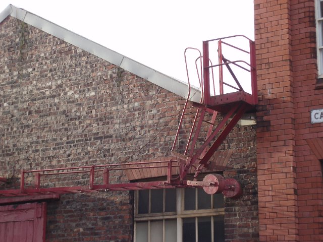 a metal firescape ladder on a old brick warehouse