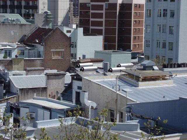 elevated view looking across rooves in a city