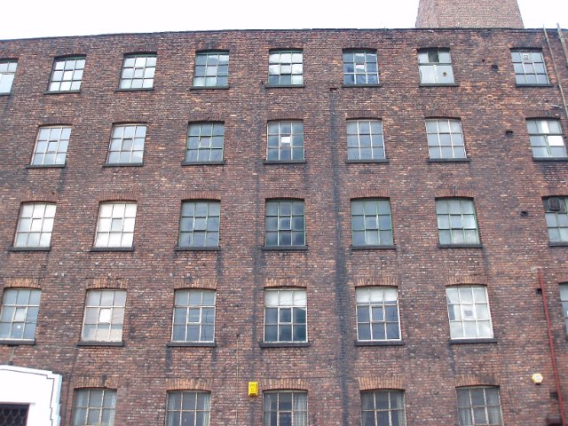windows on a large brick warehouse