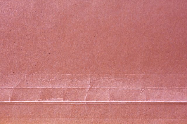 crinkled texture of folds in the top of a paper document folder