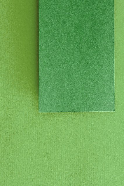 a green textured paper label on green background with space for text to be inserted