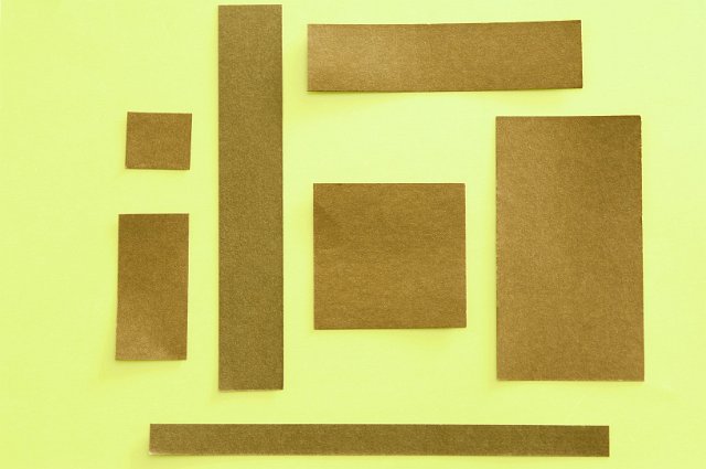 squares of craft paper on a yellow background with spaces for text