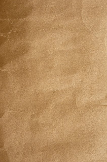 creased surface of a brown or dark manilla paper folder
