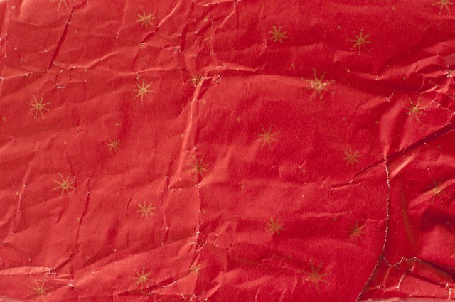 red star patterned creased and crumpled gift wrapping paper