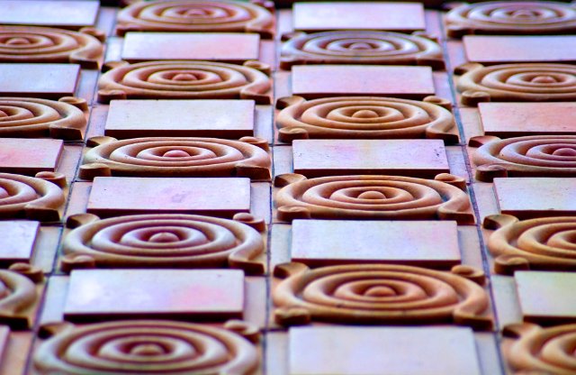 decorative clay tiles on an old building