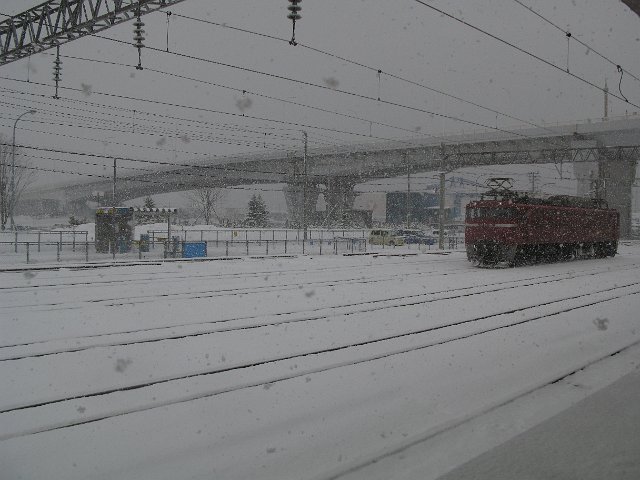 looking across a railway yard blanketed with snow