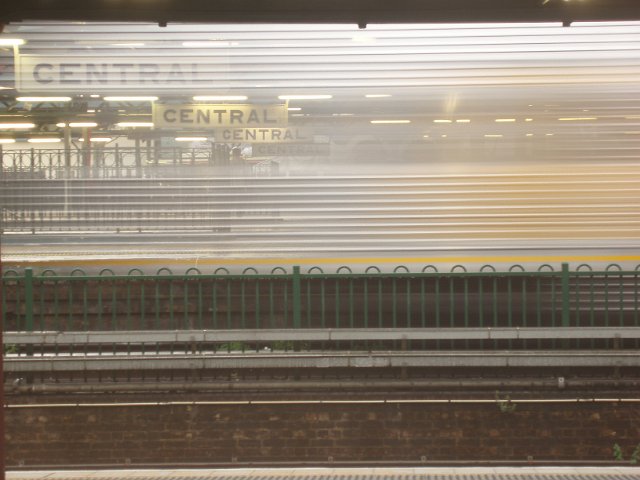 blurred image of a train hertling past a station platform