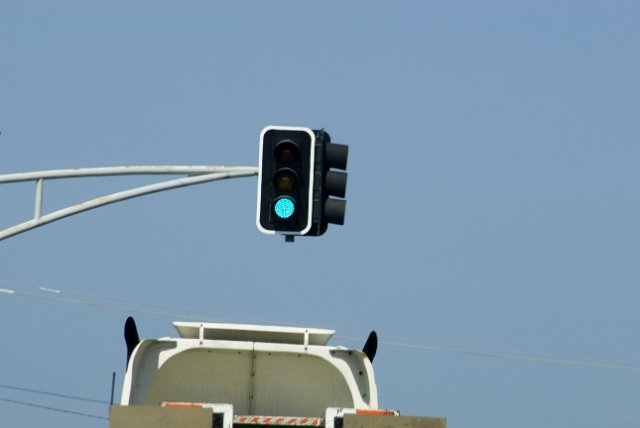 elevated green traffic light at an intersection