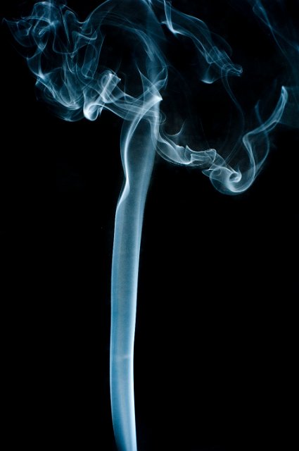 a rising column of smoke topped with a mushroom shaped cloud