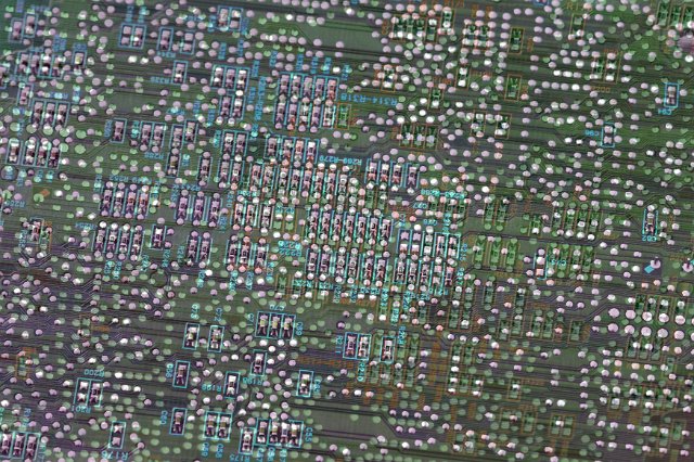 Electronic circuit board with lots of small components in blurred full frame background concept