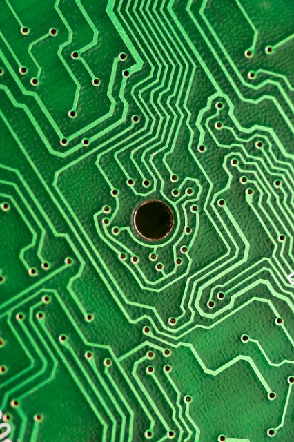 close up on the copper tracks on a green printed circuit board
