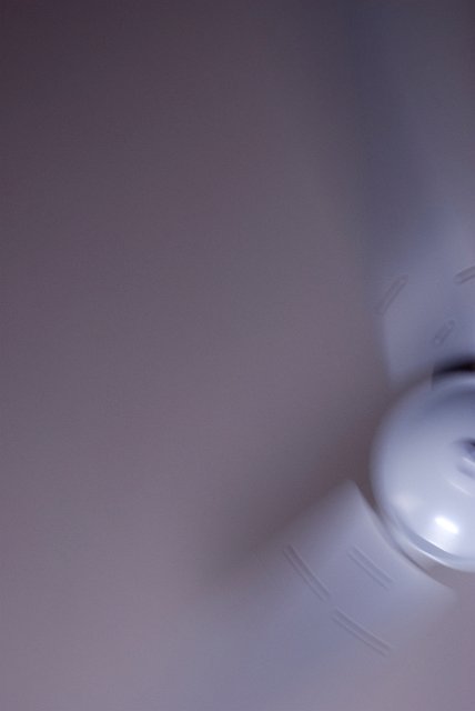 looking up at a ceiling fan with motion blur