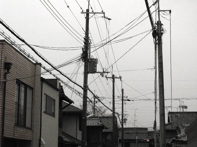 typical japanese street scene with power cables strung in all directions