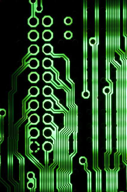 Glowing green parallel lines of electronic circuit on dark background