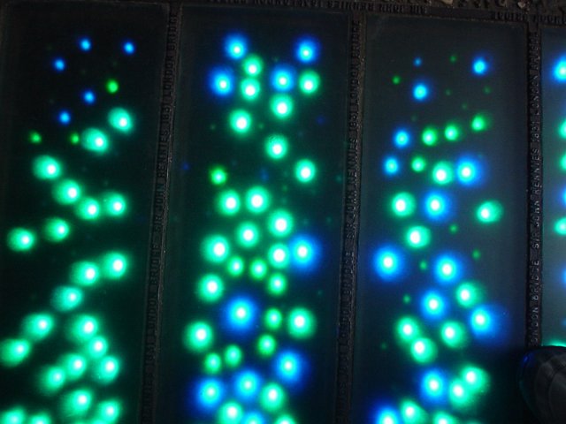 interesting blue and green leds in the pavement of a street