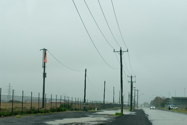 power cables stretching into the distance pictured on a rainy day